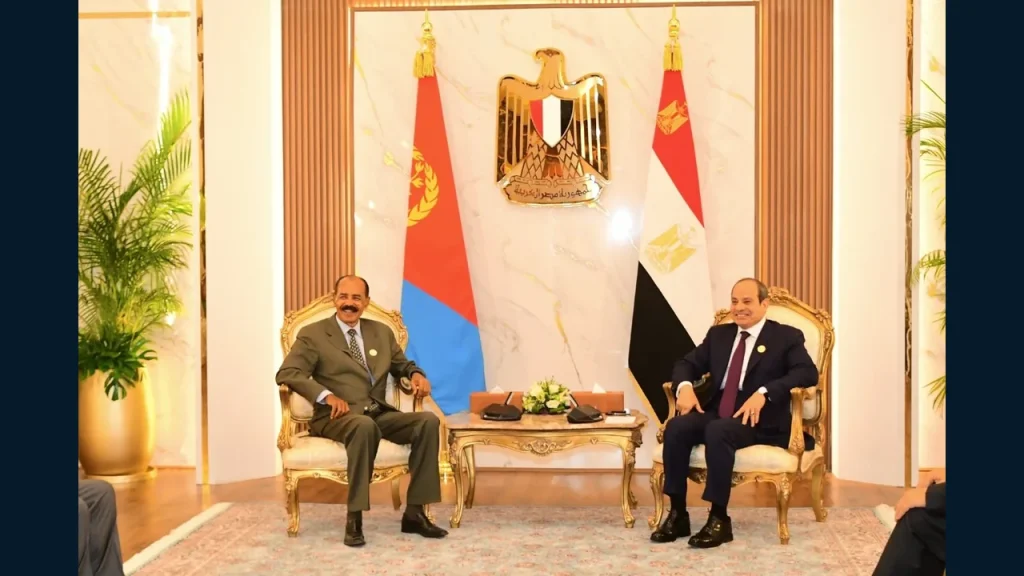 Bilateral meeting with Eritrean and Egyptian flags displayed.